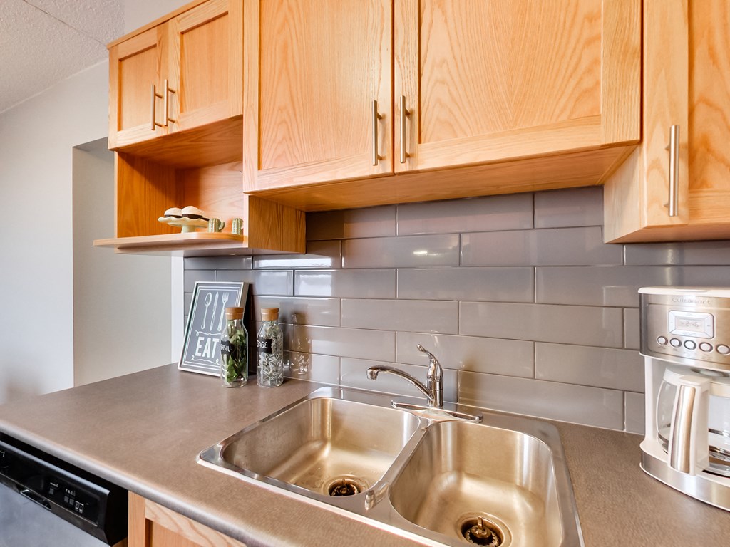 a kitchen with a sink and wooden cabinets