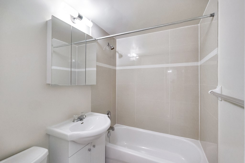 A white sink and toilet in a small bathroom.