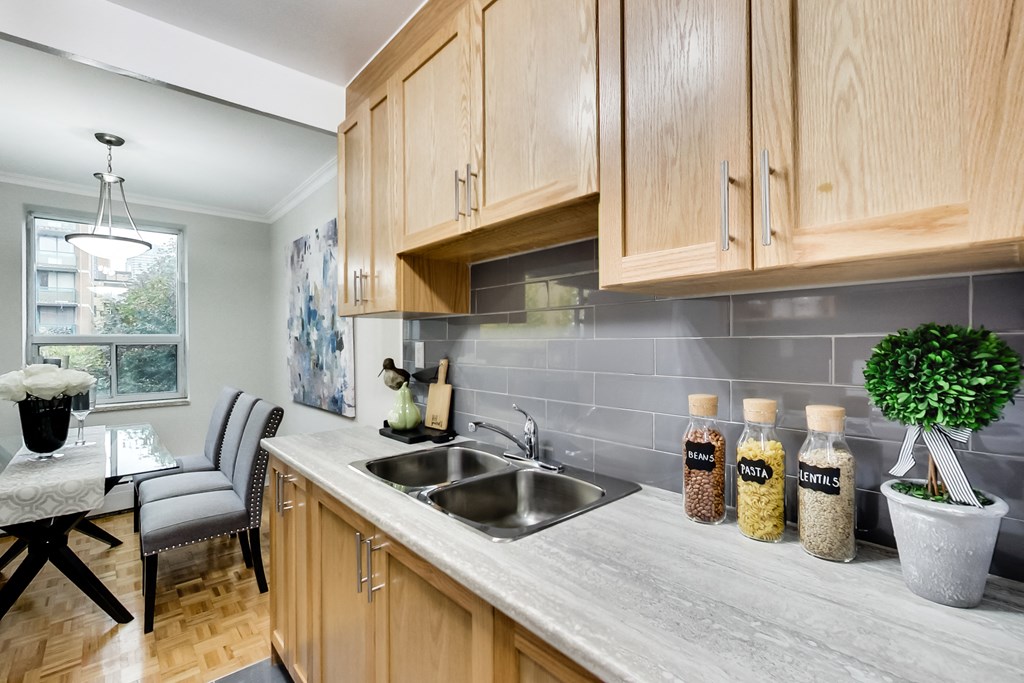 a kitchen with wooden cabinets and a sink and a window