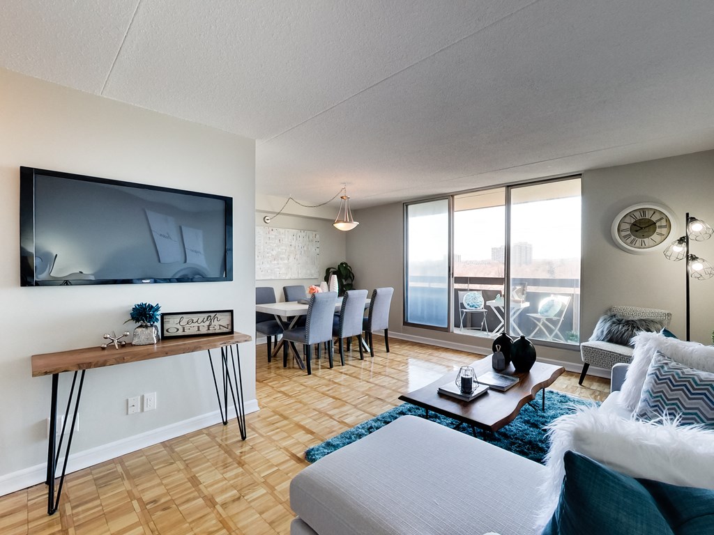a living room with a couch and a tv and a dining room table