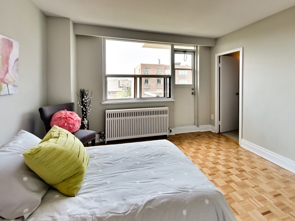a bedroom with a large bed and a window