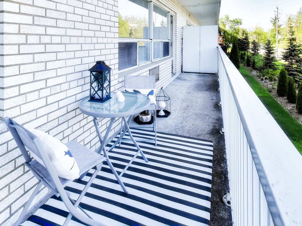 a small patio with a table and chairs on it