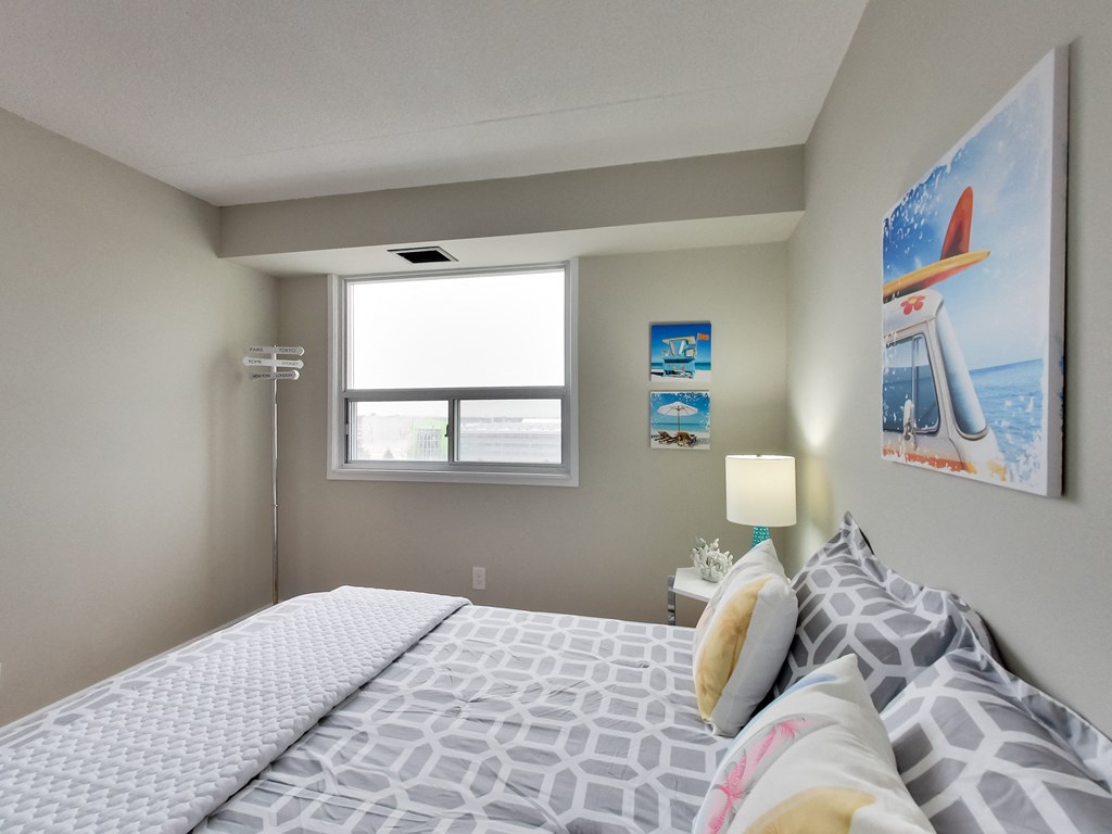 a bedroom with a large bed and a window