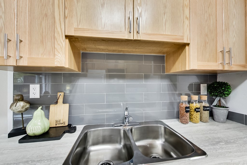 a kitchen with a sink and wooden cabinets