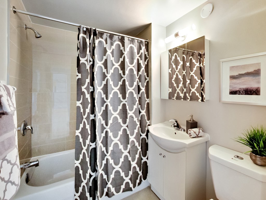 a bathroom with a shower and a sink and a toilet