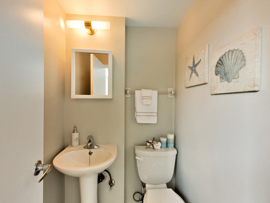 a bathroom with a sink and a toilet and a mirror