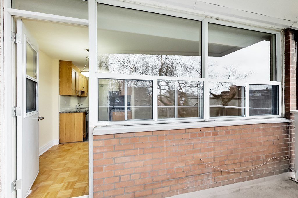 A view of a kitchen through a window.
