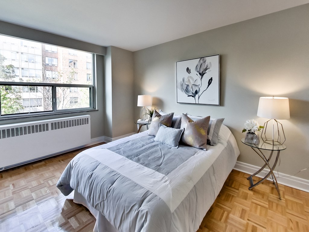 a bedroom with a large bed and a window