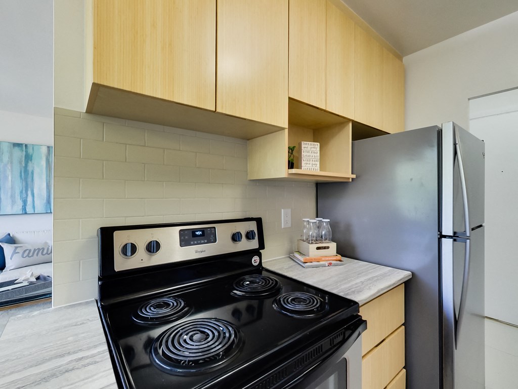 a kitchen with a stove and a refrigerator
