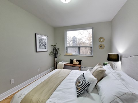 a bedroom with a large bed and a window