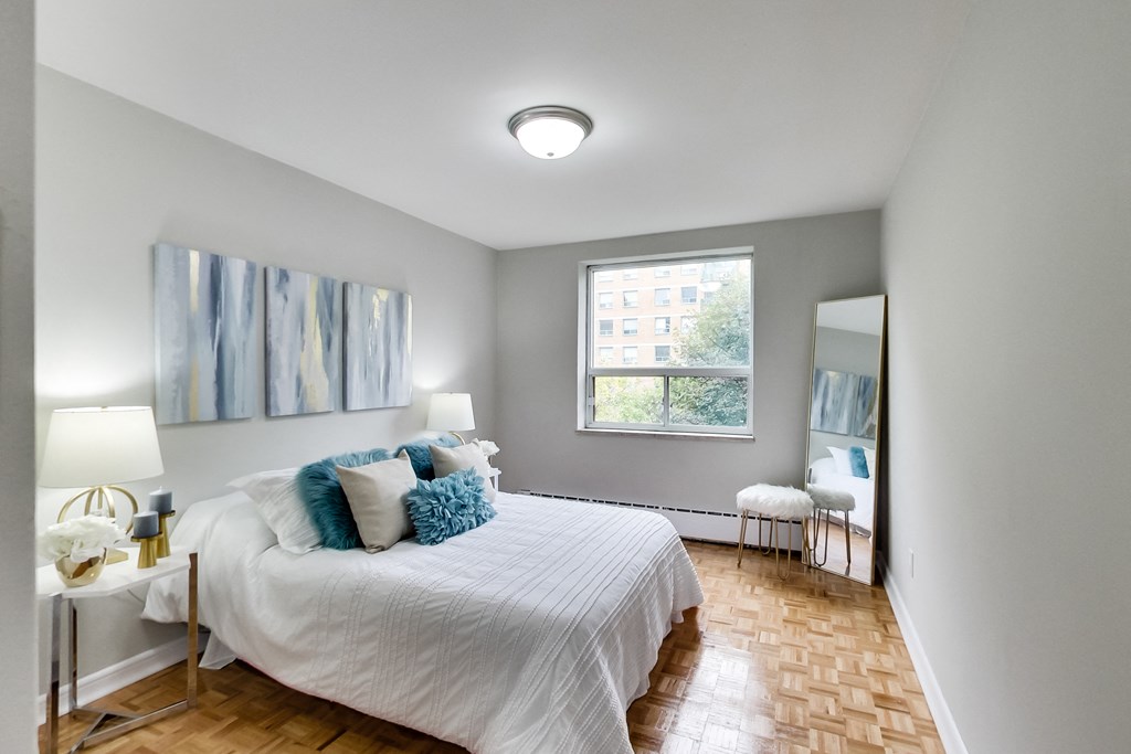 a bedroom with a large bed and a window