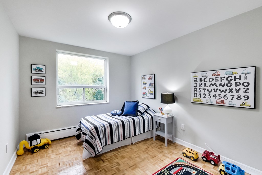 a bedroom with a bed and toys on the floor