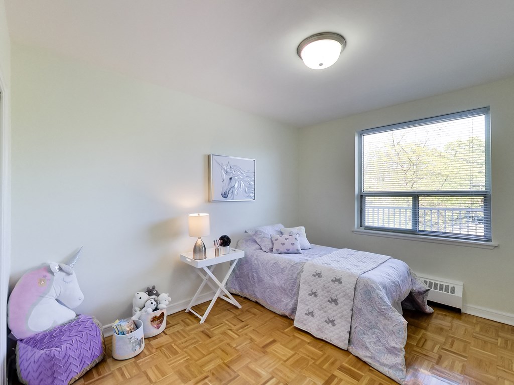 a bedroom with a bed and a unicorn chair