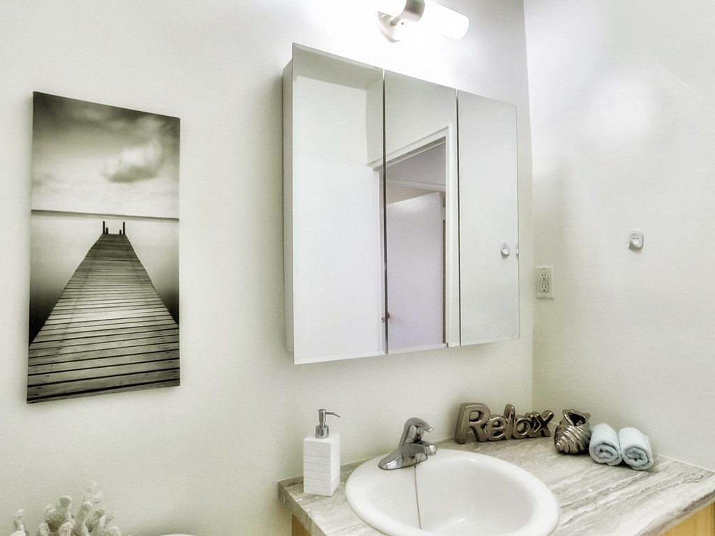 an image of a bathroom with a sink and a mirror