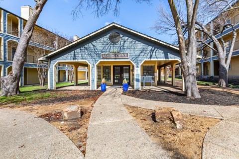 A blue building with the words "Leasing Entrance" on it.