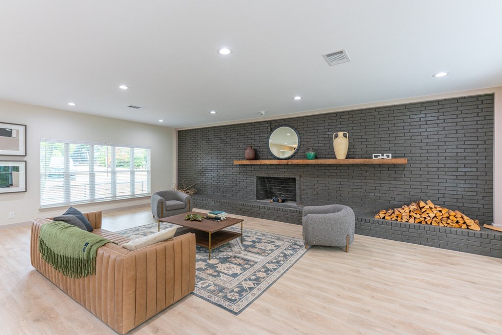 a living room with a couch and chairs and a fireplace