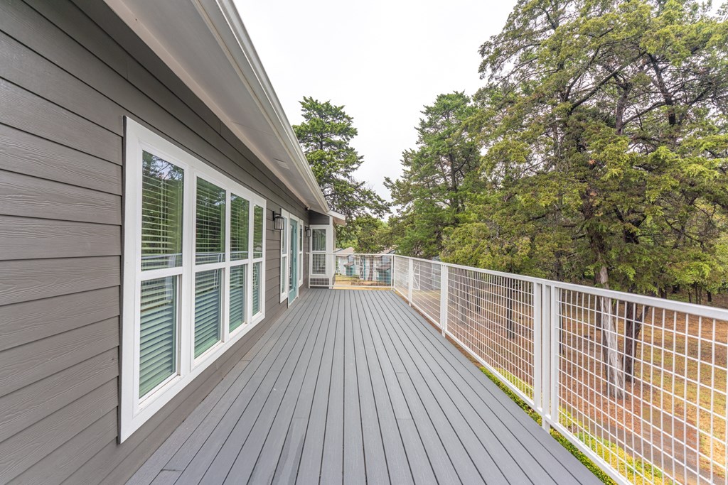 the view from the deck of a home with a white fence