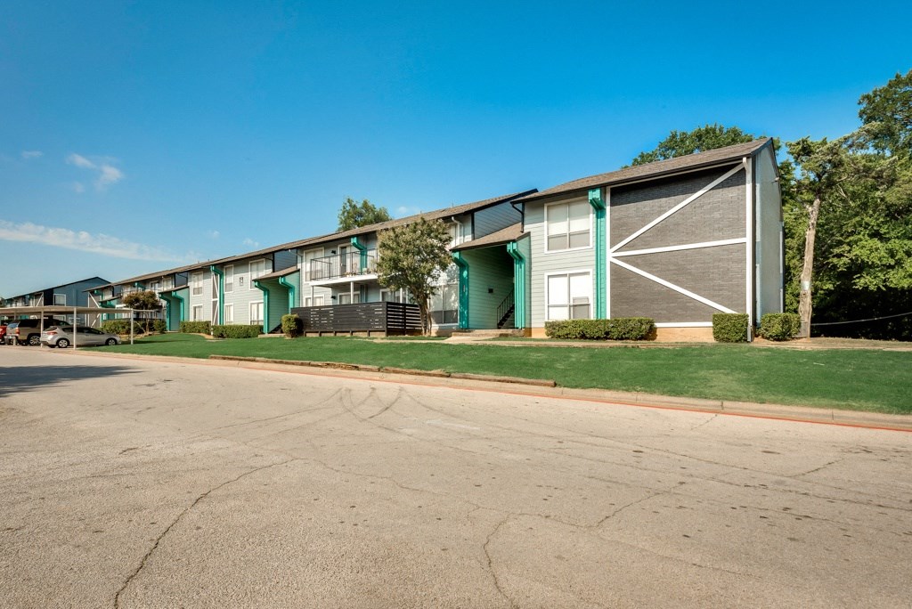 an empty street in front of an apartment building