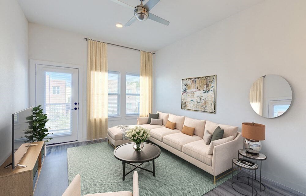 a living room with a couch and a ceiling fan