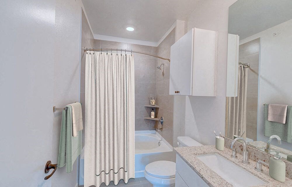a bathroom with a shower curtain and a toilet and a sink