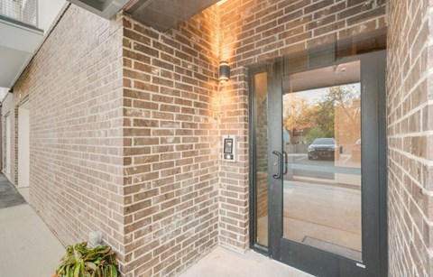 the entrance to a brick building with a glass door