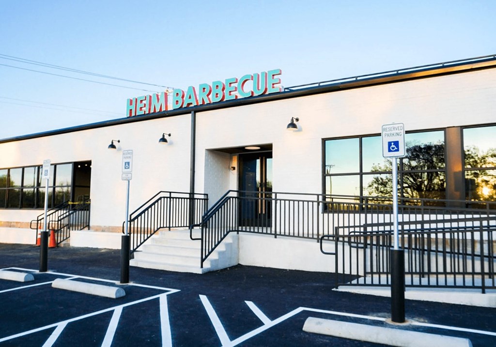 the front of a building with a sign that sayshem barbeque on it