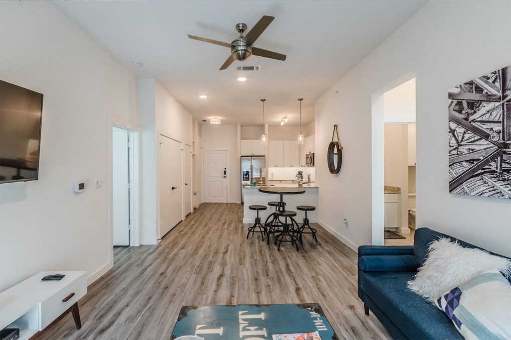 a living room with a couch and a ceiling fan