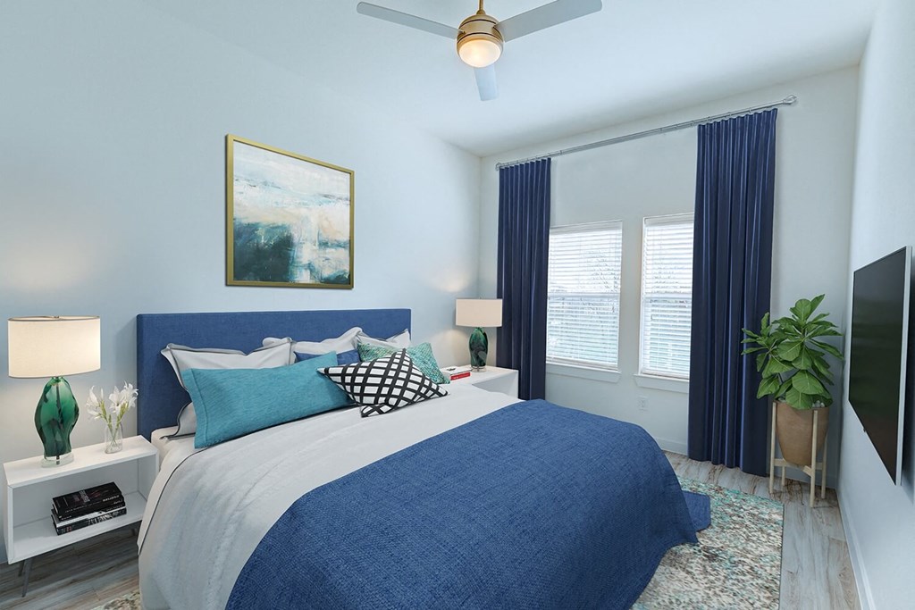 a blue and white bedroom with a bed and a ceiling fan