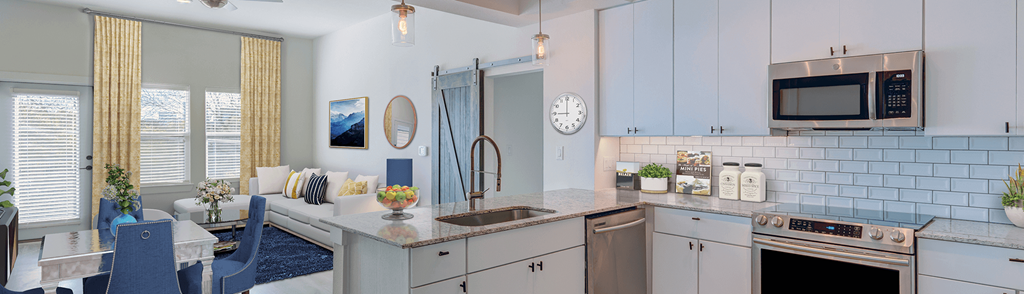 a kitchen with white cabinets and a sink and a microwave