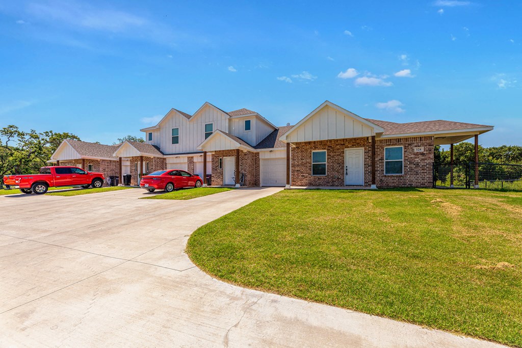 a house with two red cars parked in front of it