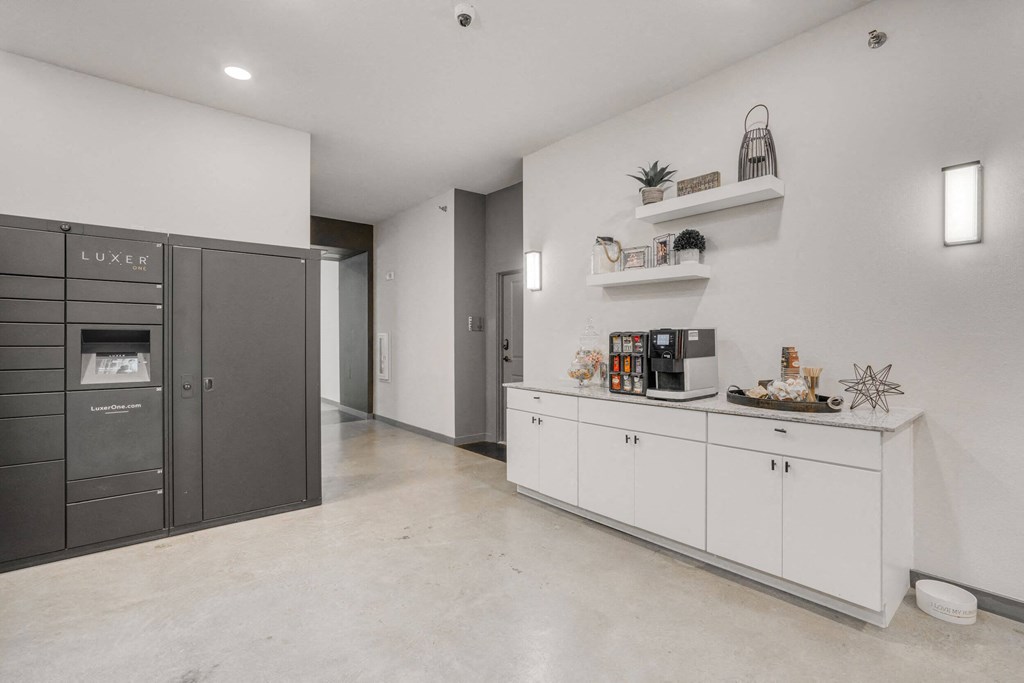 a kitchen with white cabinets and a stainless steel refrigerator