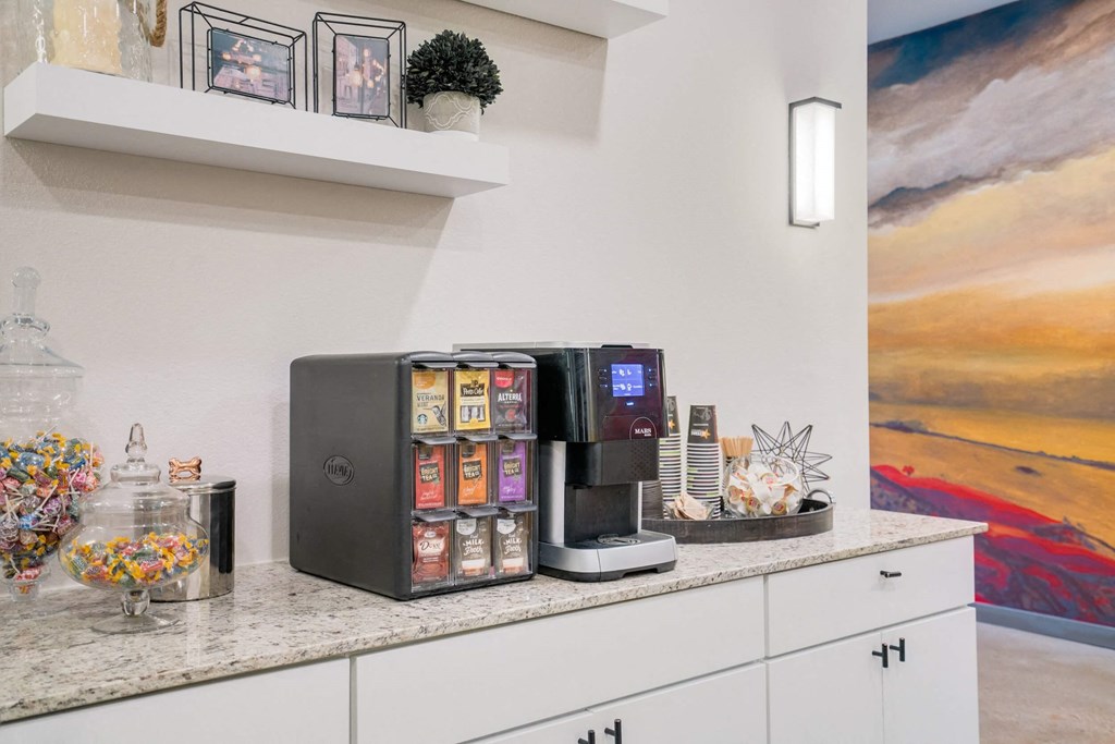 a kitchen with a coffee machine and a counter top with food on it