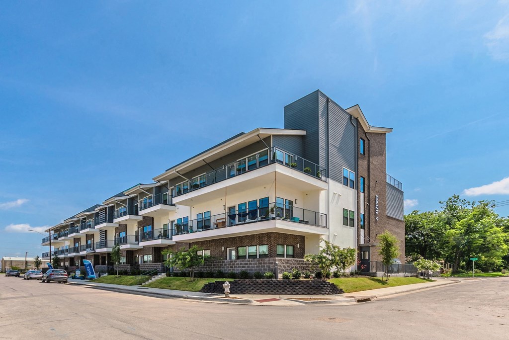 a large apartment building on the corner of a street