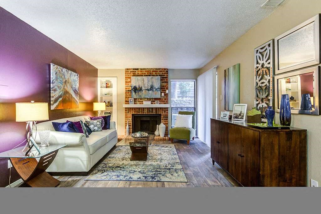 a living room with a white couch and a fireplace