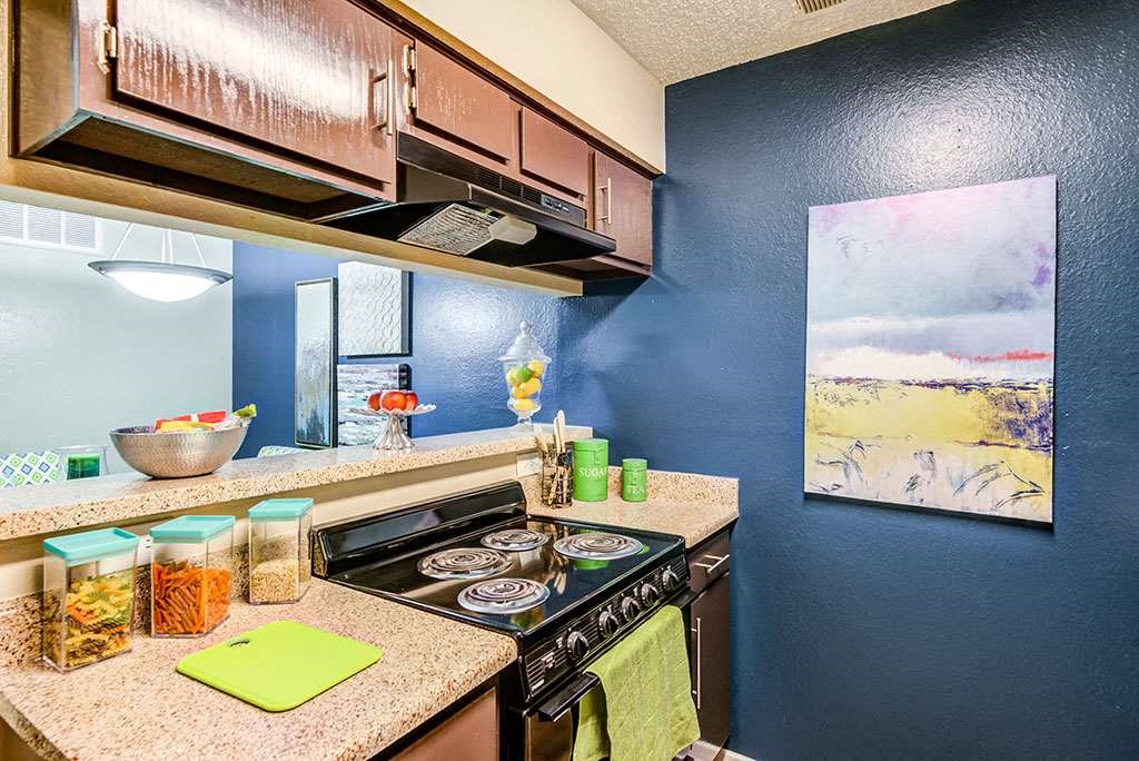 a kitchen with a stove top oven and a sink