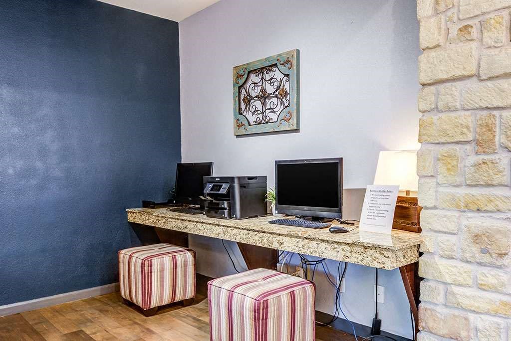 a desk with a computer and a monitor on it