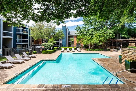 a large swimming pool with chairs around it