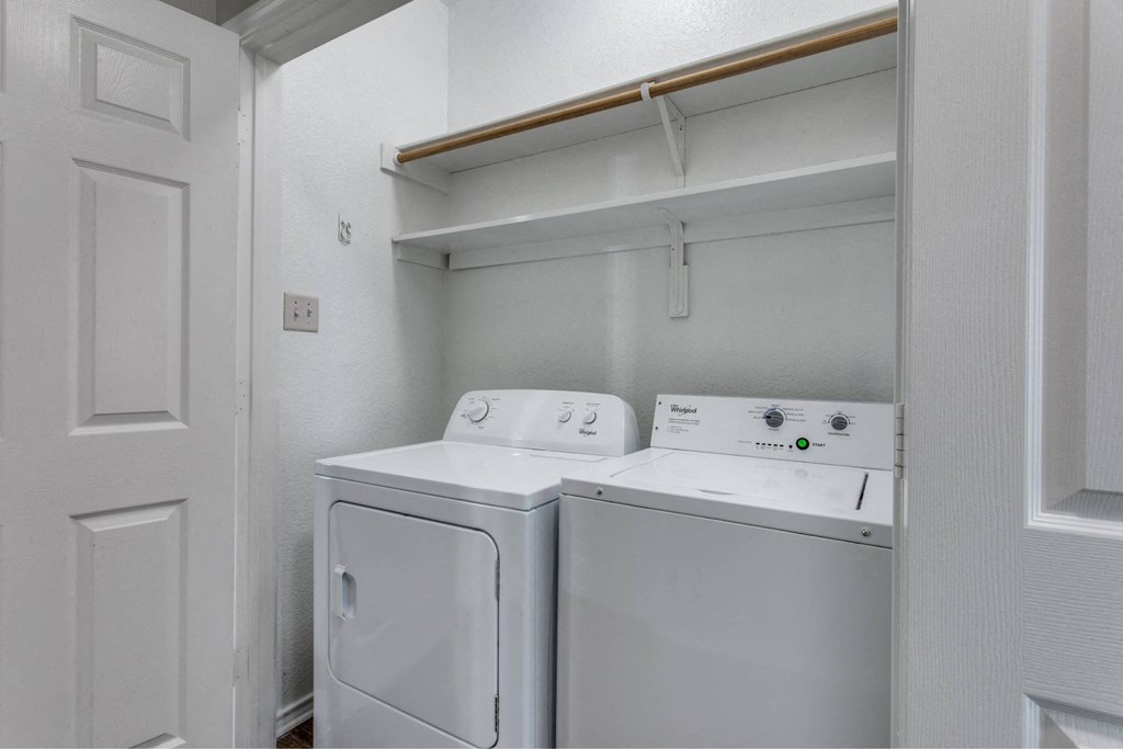 a washer and dryer in a room with a white door
