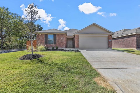 a house with a yard and a sidewalk in front of it