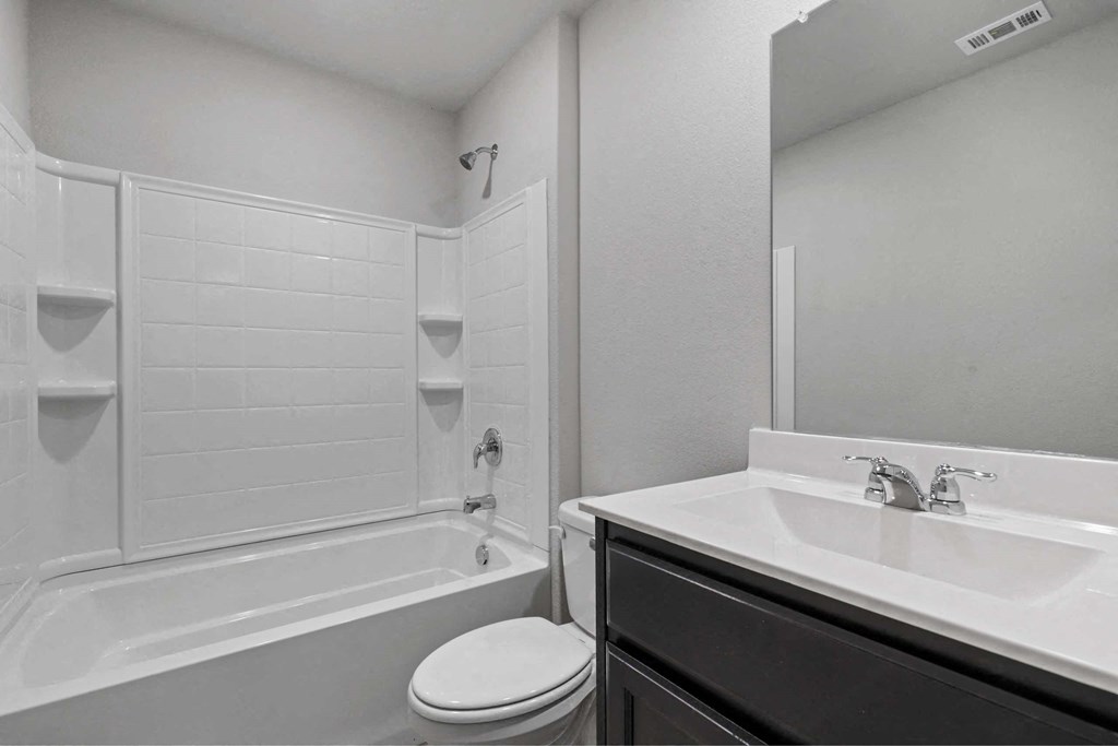 a bathroom with a sink and a toilet and a tub