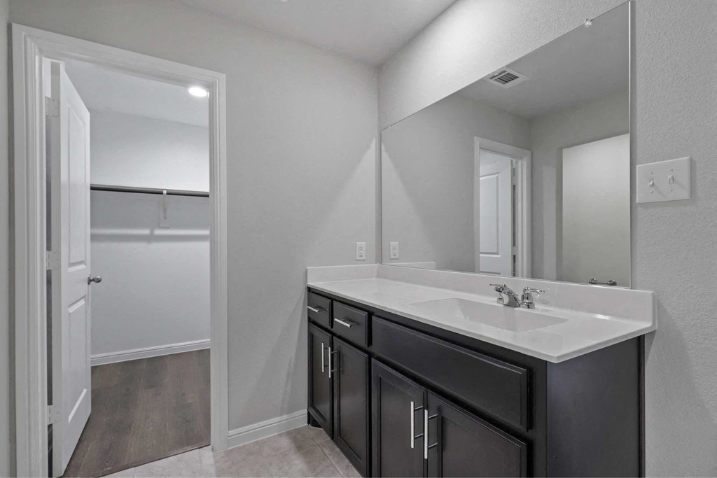 an empty bathroom with a sink and a mirror