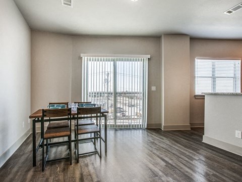 a dining room with a table and chairs and a window