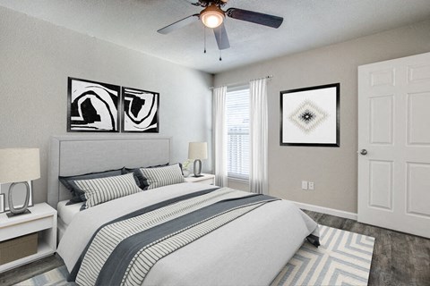 a bedroom with a bed and a ceiling fan