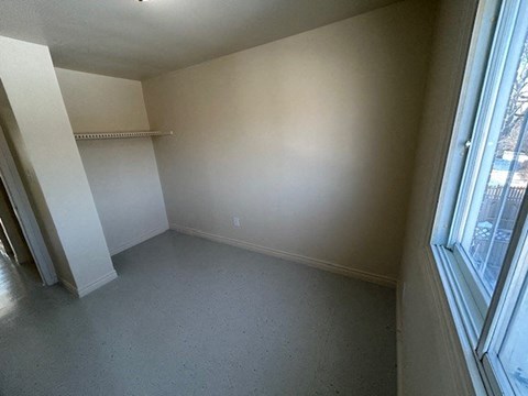 an empty living room with a large window