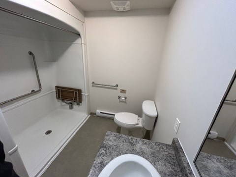 A bathroom with a toilet, sink, and bathtub.