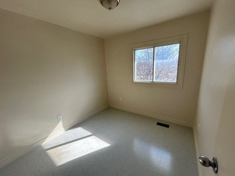 a small empty room with a window in it