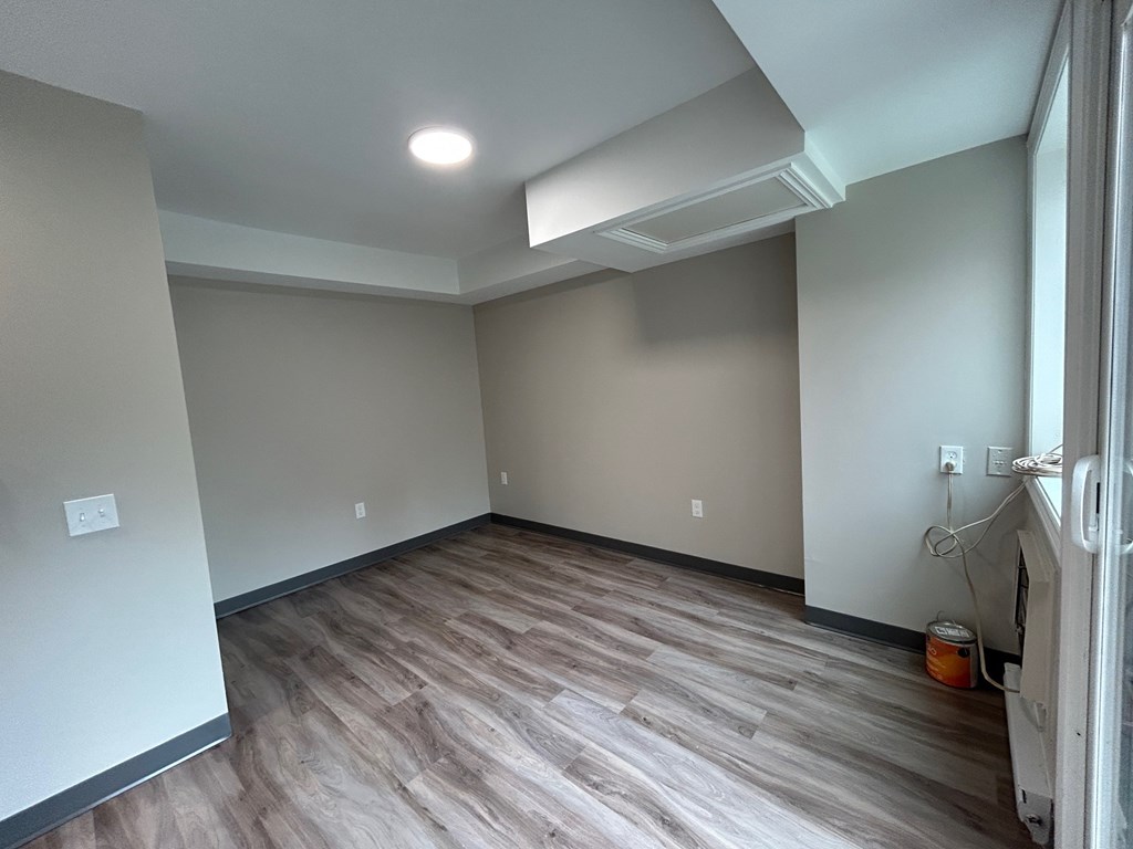 A room with a wooden floor and a white ceiling.