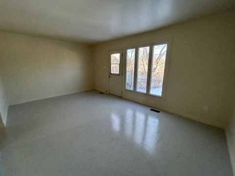 an empty living room with a large window