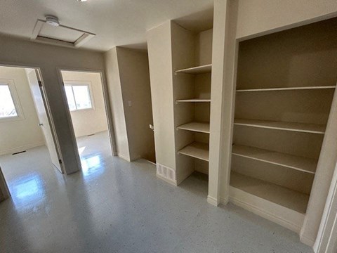 a empty room with shelves on the wall