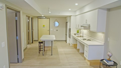 A kitchen with a table and chairs in the middle of the room.